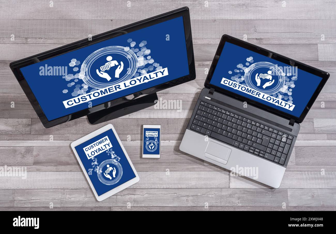 Customer loyalty concept shown on different information technology devices Stock Photo