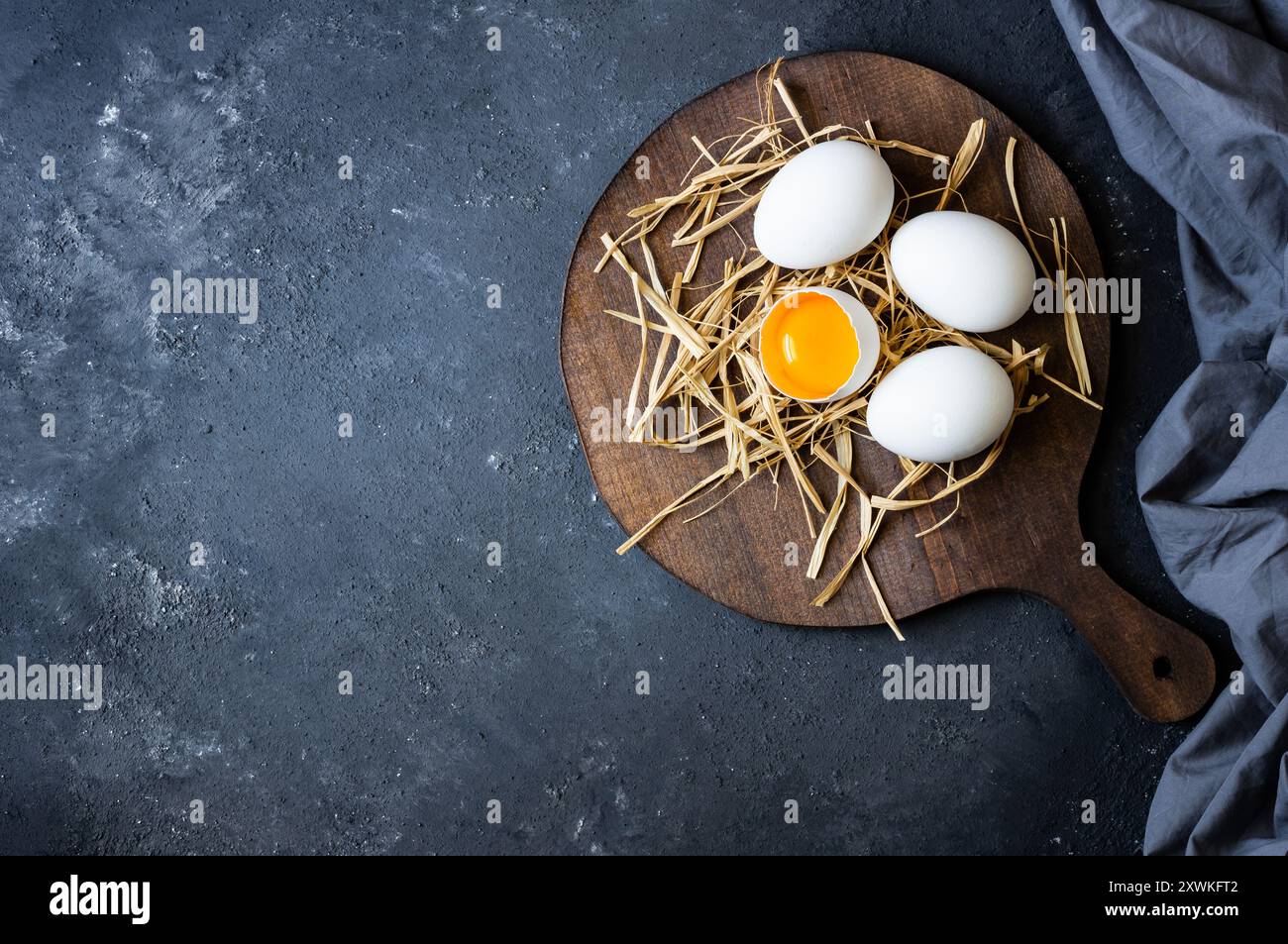 Raw white farm chicken eggs with egg yolk on rustic table Stock Photo