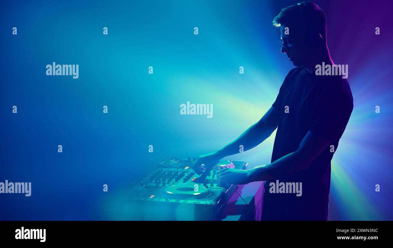 DJ immersed in of vibrant lights, mixing beats as colors pulse around ...