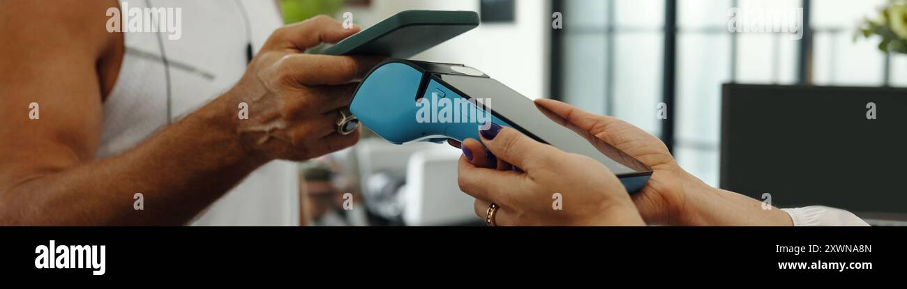 Man Paying With Mobile Phone For Training Stock Photo