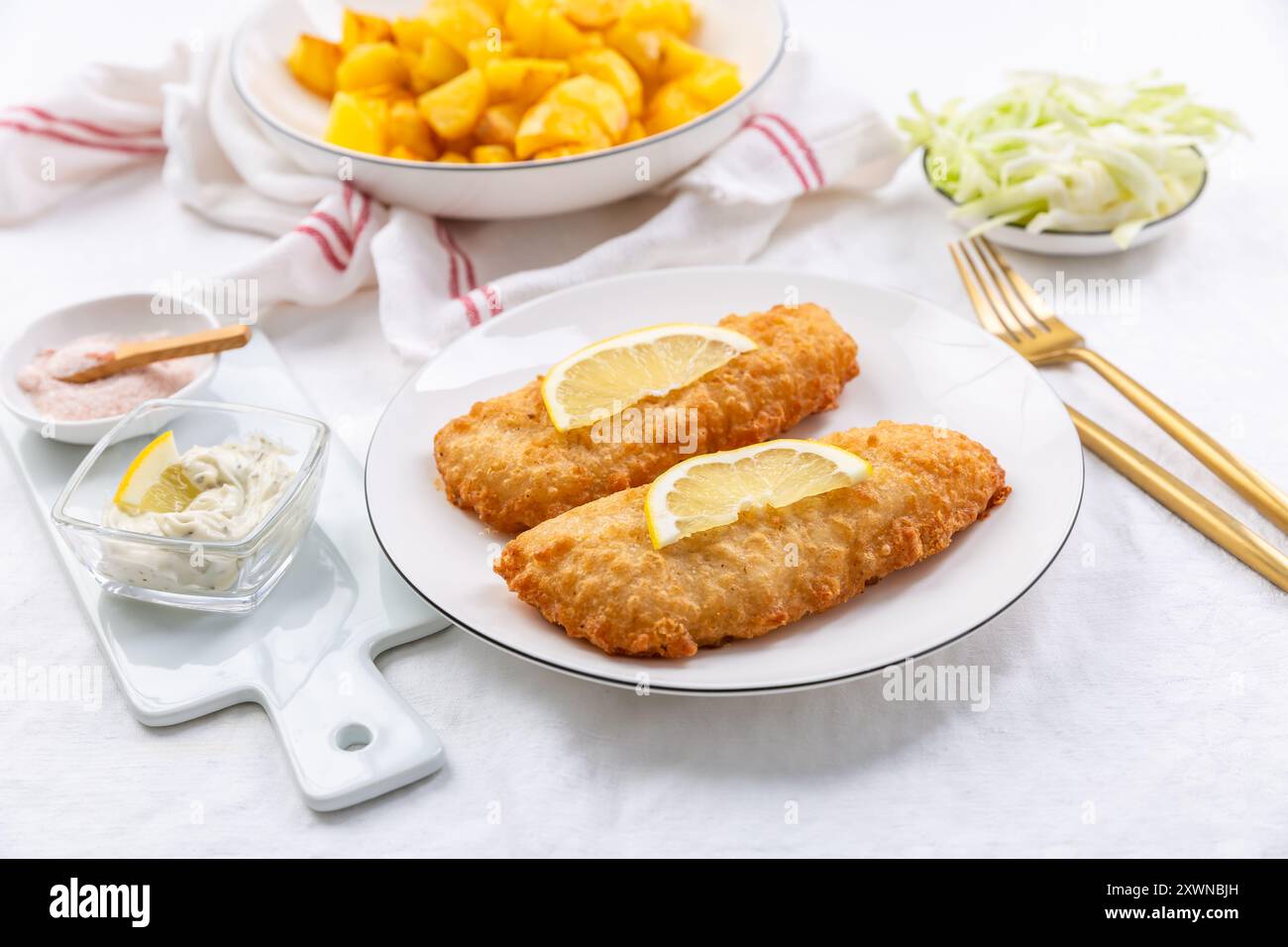 Crispy breaded fish with dipping sauce and lemon Stock Photo