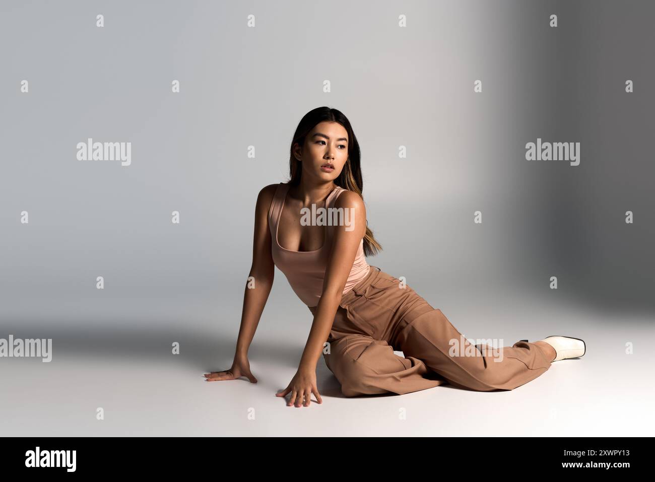 Woman poses camera in studio hi-res stock photography and images - Alamy