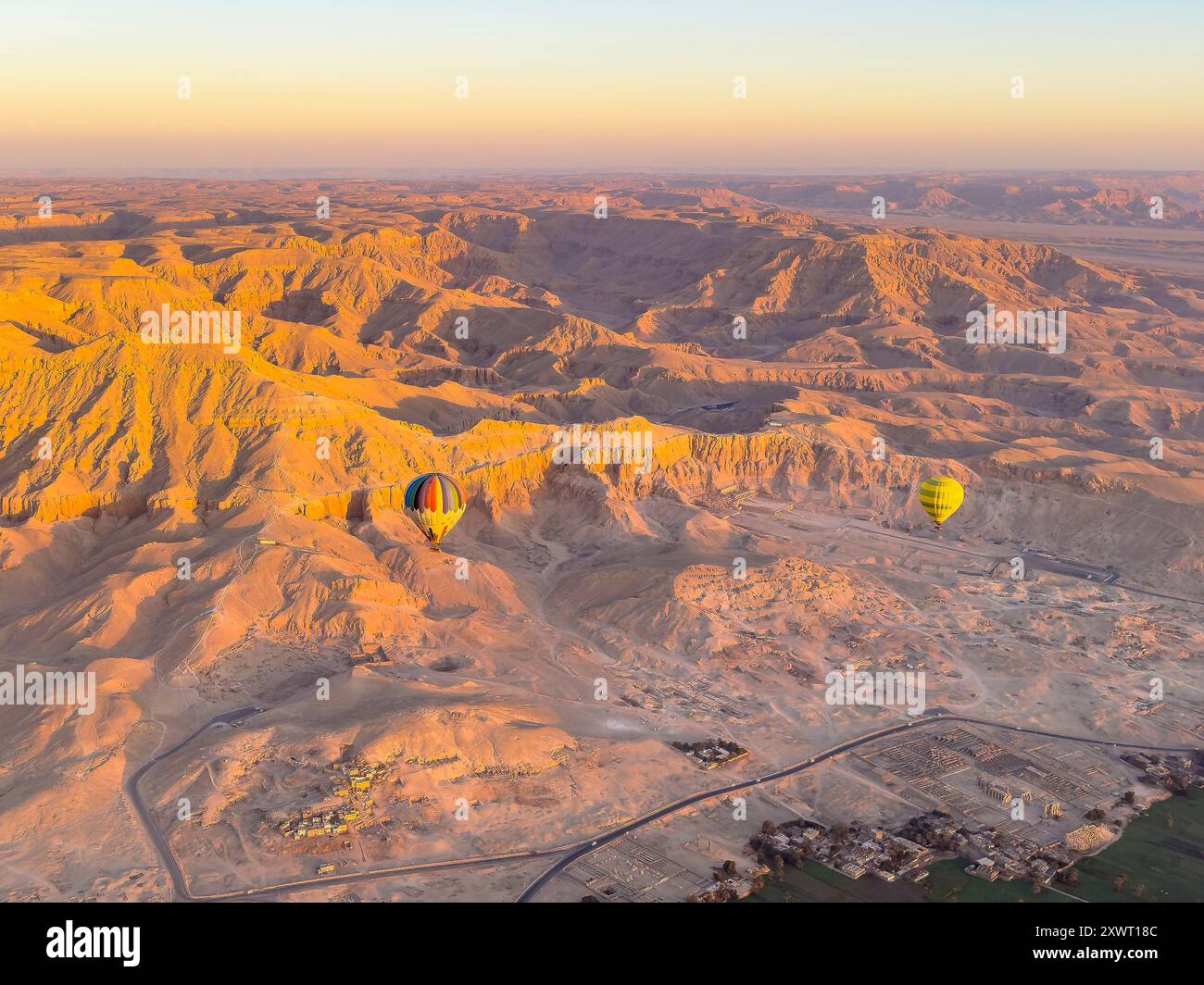 Enjoy a peaceful hot air balloon ride over the Nile River, offering stunning views of Luxor's ancient temples and the desert where pharaohs once ruled Stock Photo