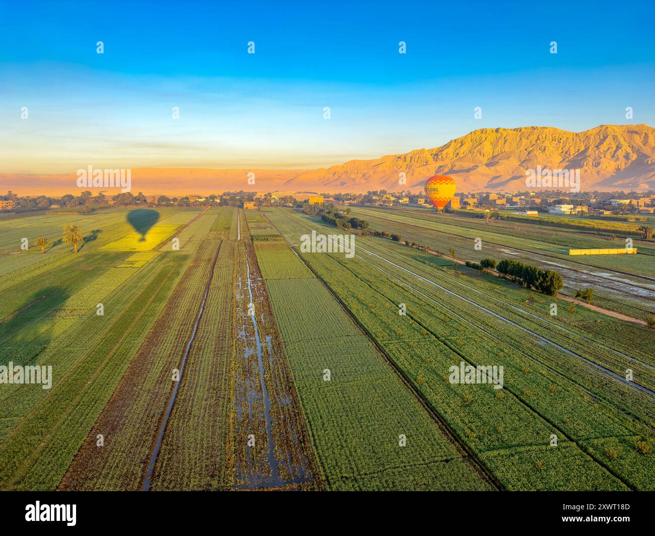 Discover the magic of Luxor from above as you soar over the Nile River in a colorful hot air balloon. Stock Photo