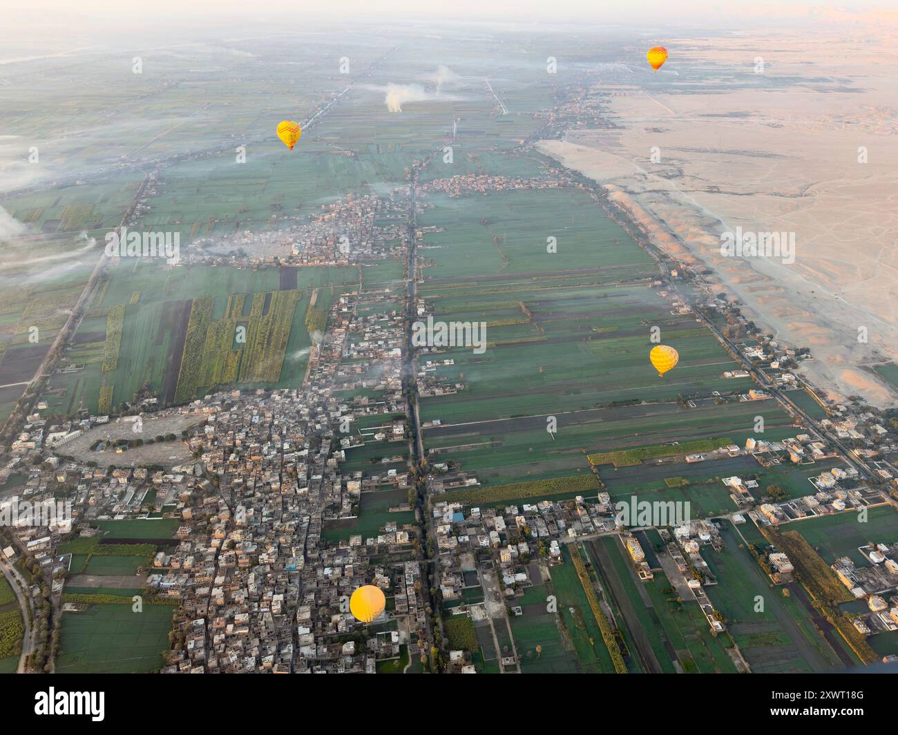 Experience the magic of ancient Egypt as colorful hot air balloons soar gracefully over the Nile River and the desert landscapes of Luxor's Thebes. Stock Photo