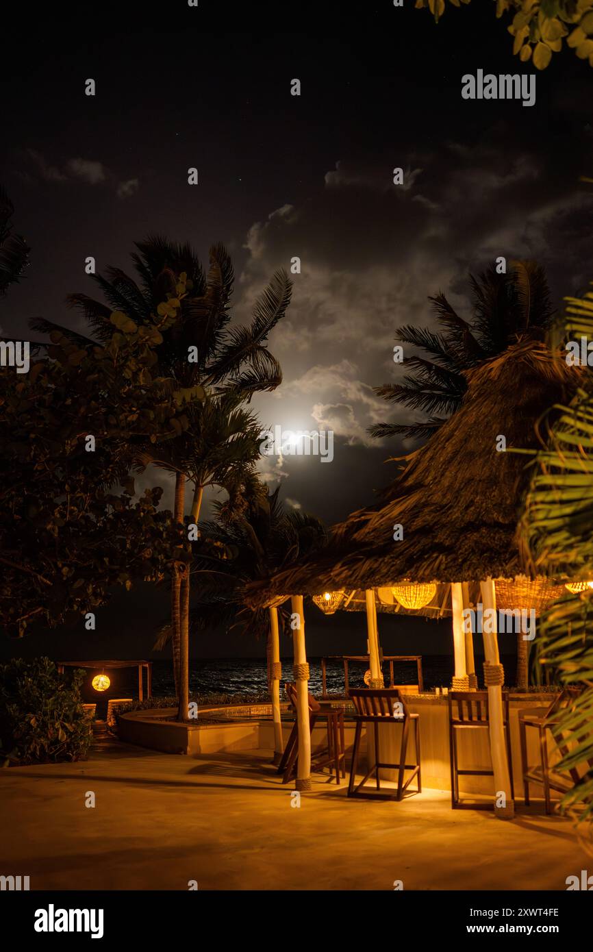 Moonlit Beachfront Tikki Bar, Almond Beach Resort, Hopkins, Belize Stock Photo