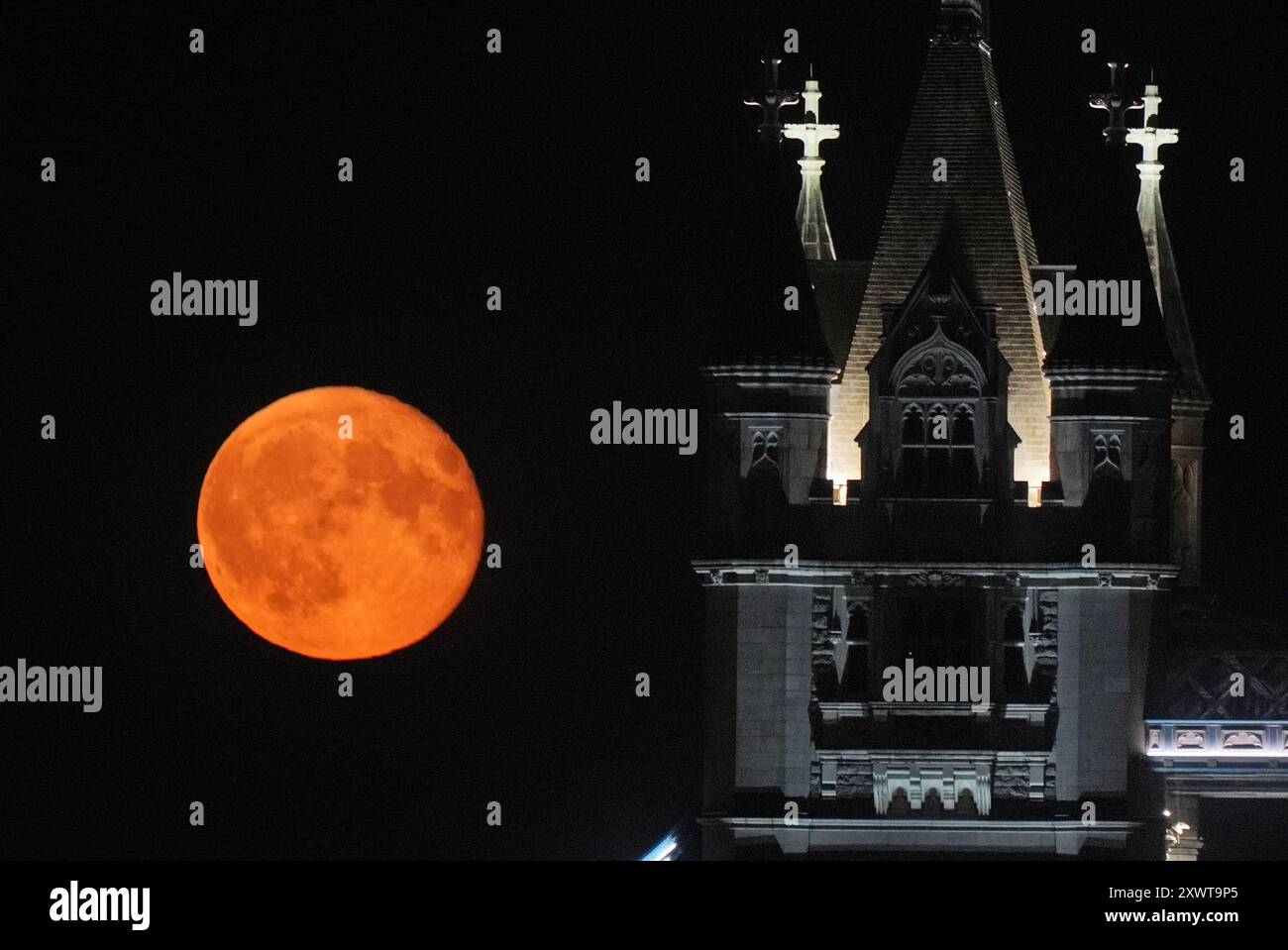 A waning gibbous moon rises over Tower Bridge in London. Picture date ...