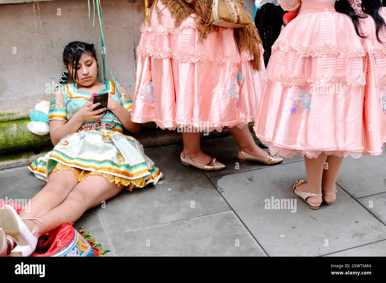 Members of a Bolivian dance group in Whitehall Place after participating in the St.Patricks Day parade in central London. March 17th 2024. Stock Photo