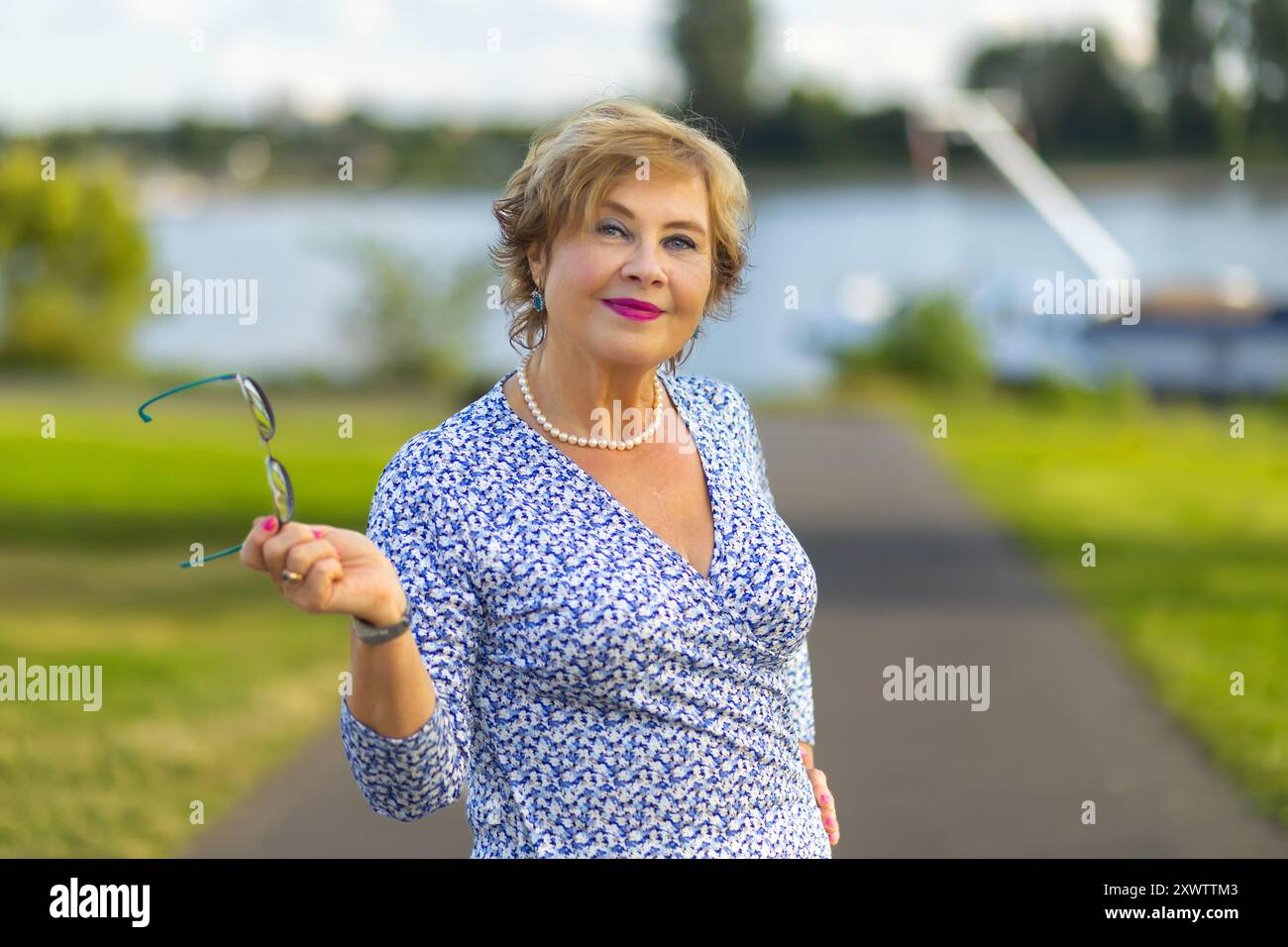 Portrait of smiling woman at the waterfront hi-res stock photography ...