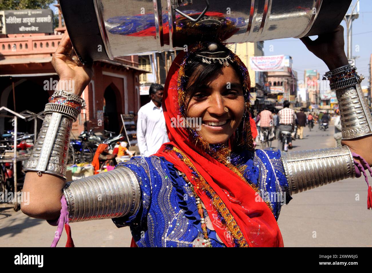A Rajasthani beauty walks home with a barrel on her head. Photo taken ...