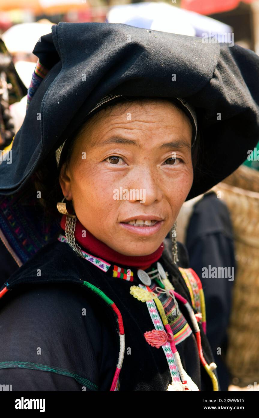 Portrait of a Black Yao woman taken at a colorful weekly market in southern Yunnan province ,by the border of Vietnam, China. Stock Photo