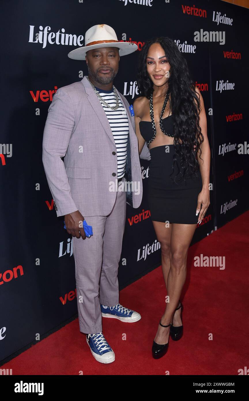 Taye Diggs, left, and and Meagan Good pose at "Terry McMillan Presents