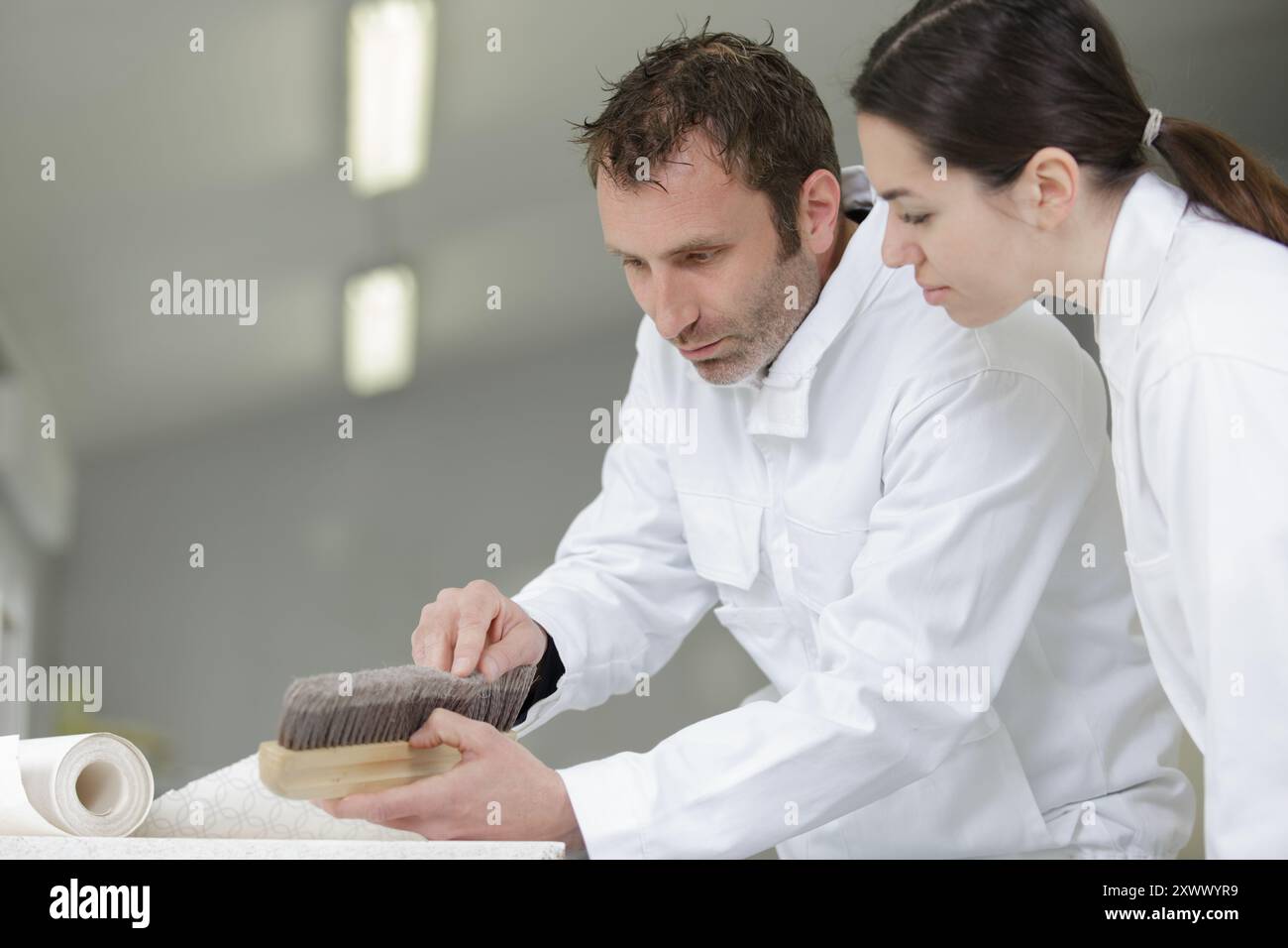 a painter with a female apprentice Stock Photo