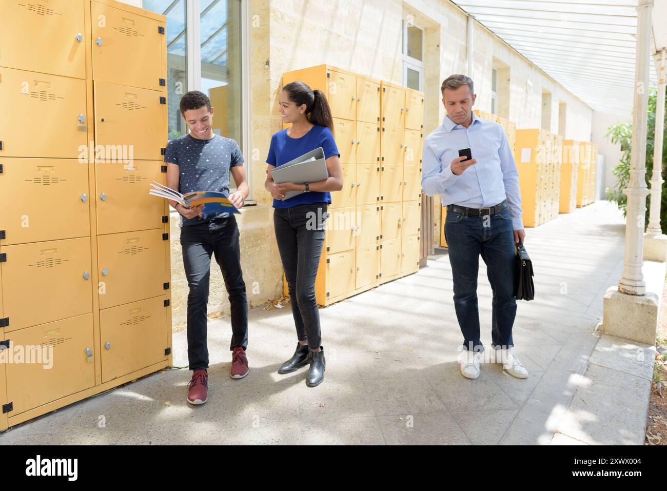 group of young students standing in a corridor after class Stock Photo ...