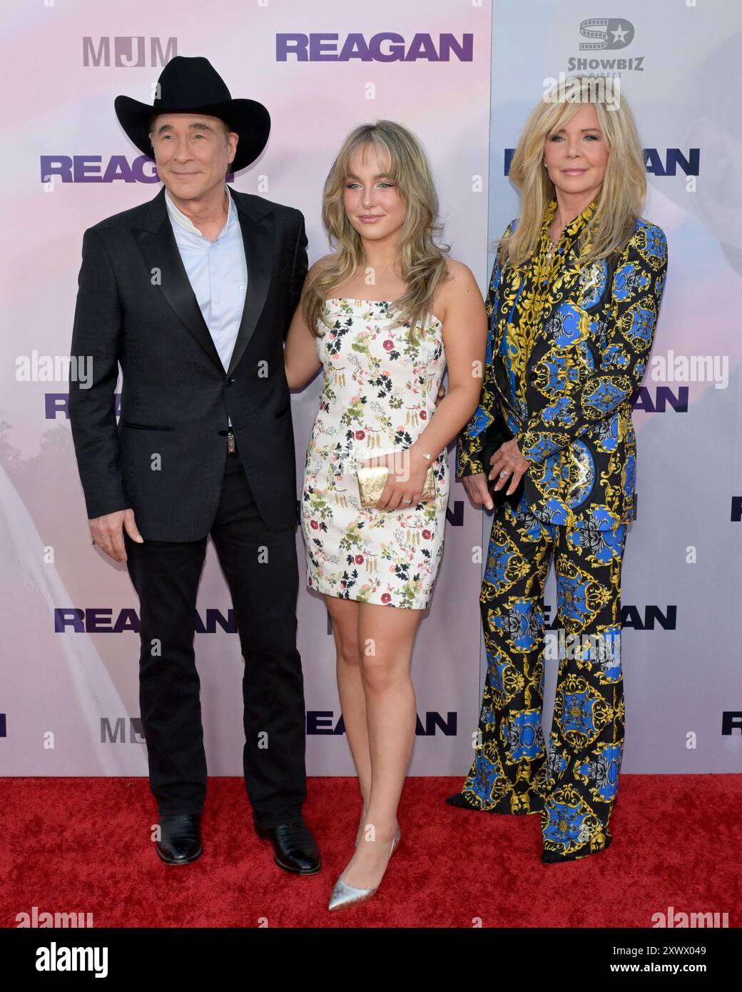 August 20, 2024, Hollywood, California, USA: (L-R) Clint Black, Lily Pearl Black and Lisa Hartman Black attend the Los Angeles Premiere of ''REAGAN' (Credit Image: © Billy Bennight/ZUMA Press Wire) EDITORIAL USAGE ONLY! Not for Commercial USAGE! Stock Photo