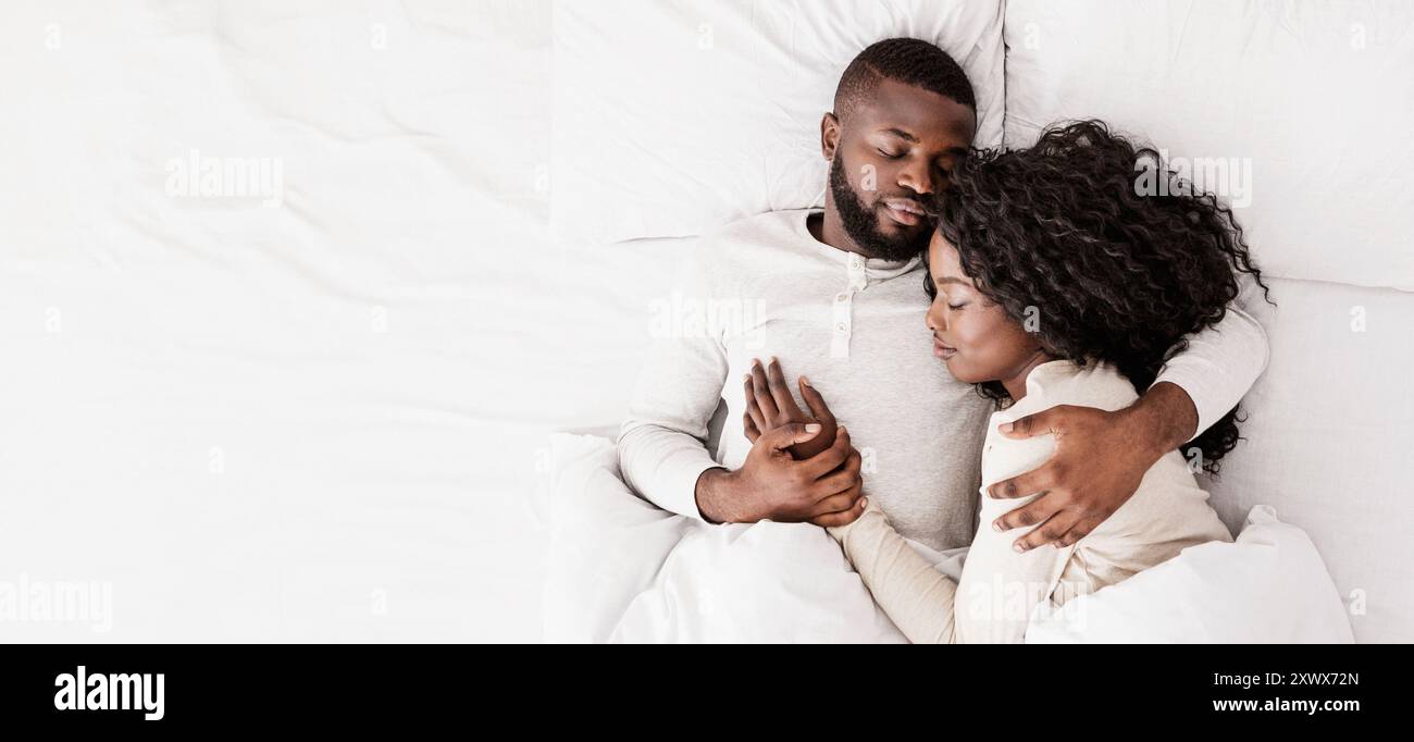 Top view of african american couple sleeping together in bed Stock ...