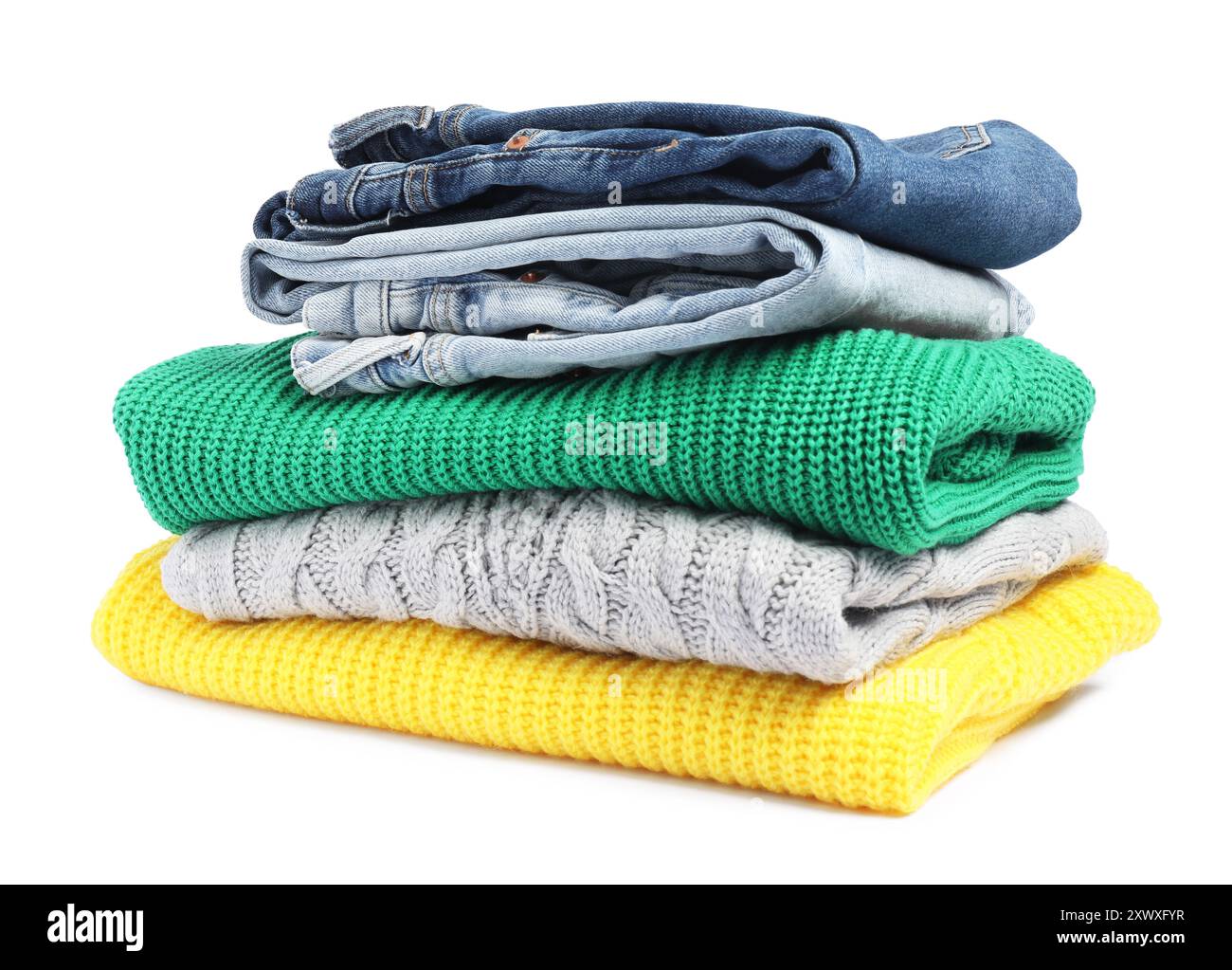 Stack of sweaters and jeans isolated on white Stock Photo