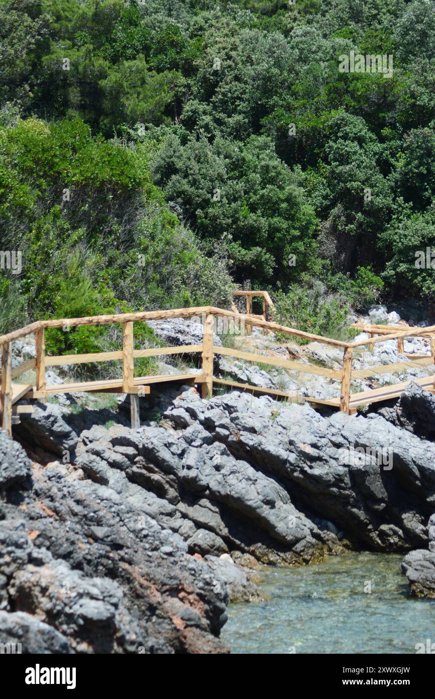 wooden hand rails on a rock above a sea surface Stock Photo - Alamy