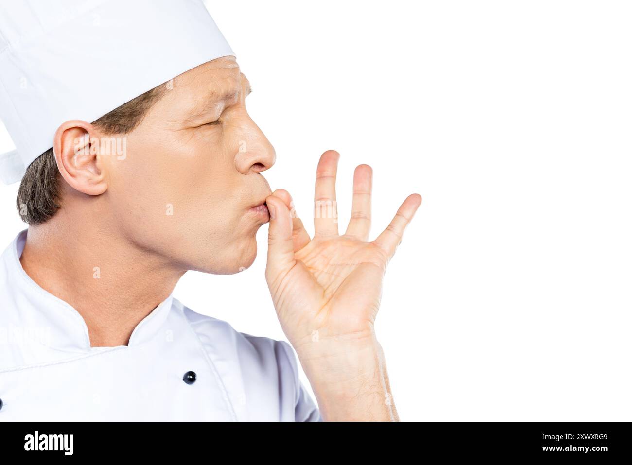 This meal is just perfect! Side view of confident mature chef in white ...