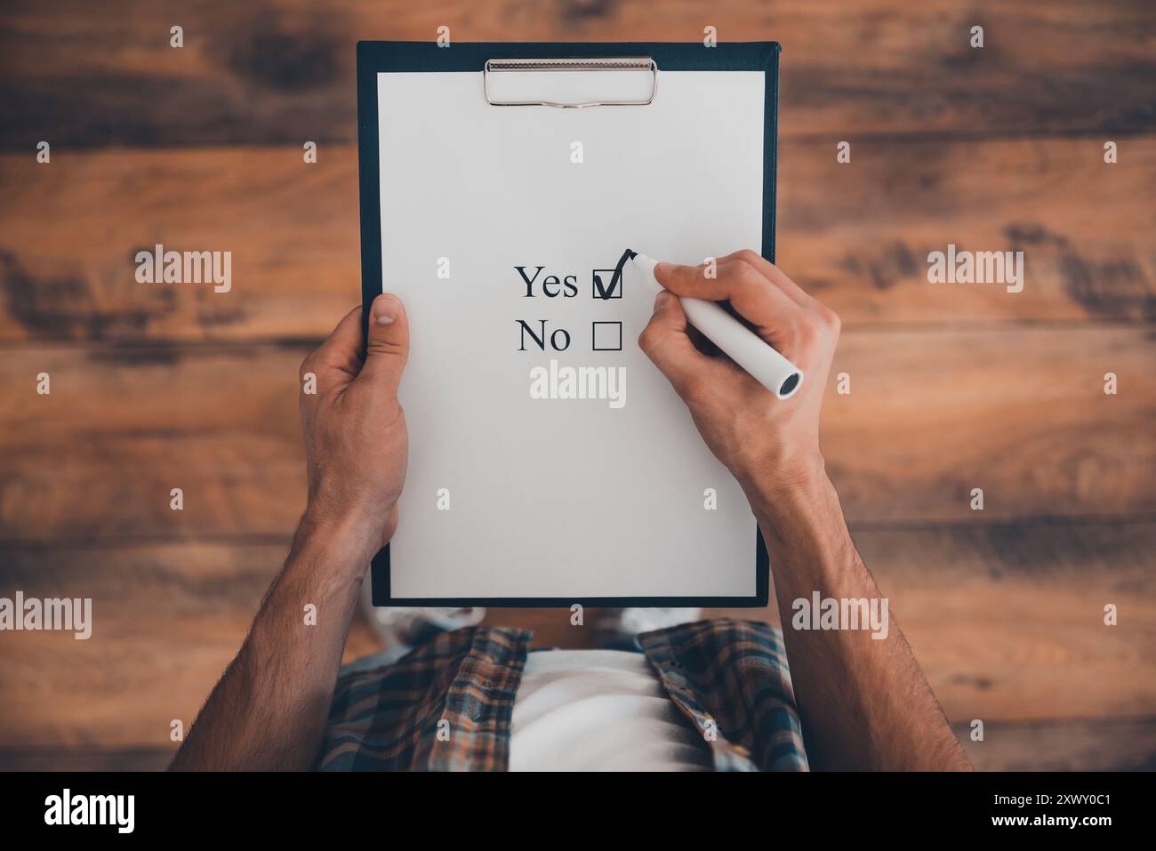 Making Check Image Making a right choice. Top view of man making a check mark in clipboard ...