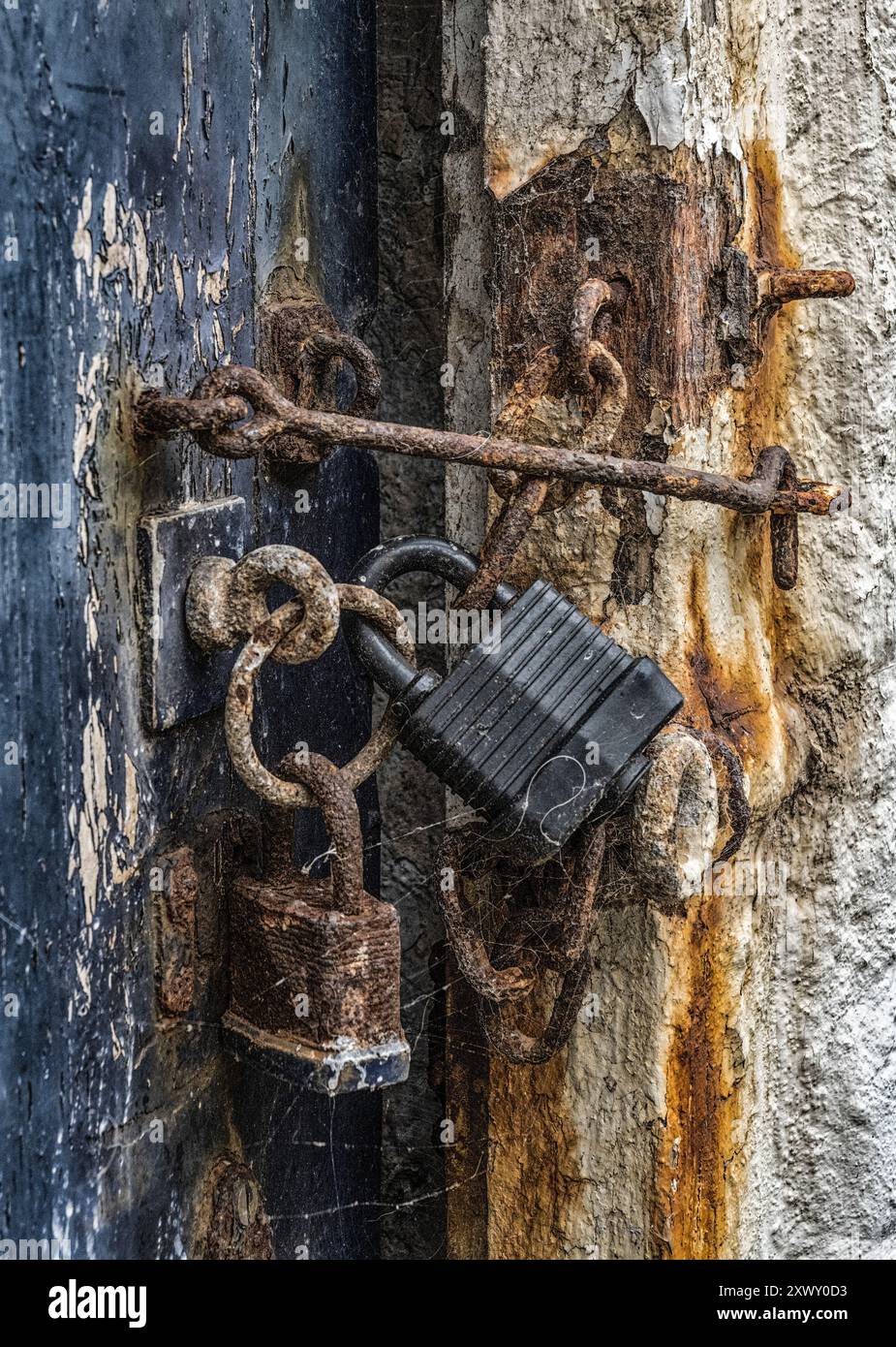 Two rusty padlocks on an ancient shed door Stock Photo