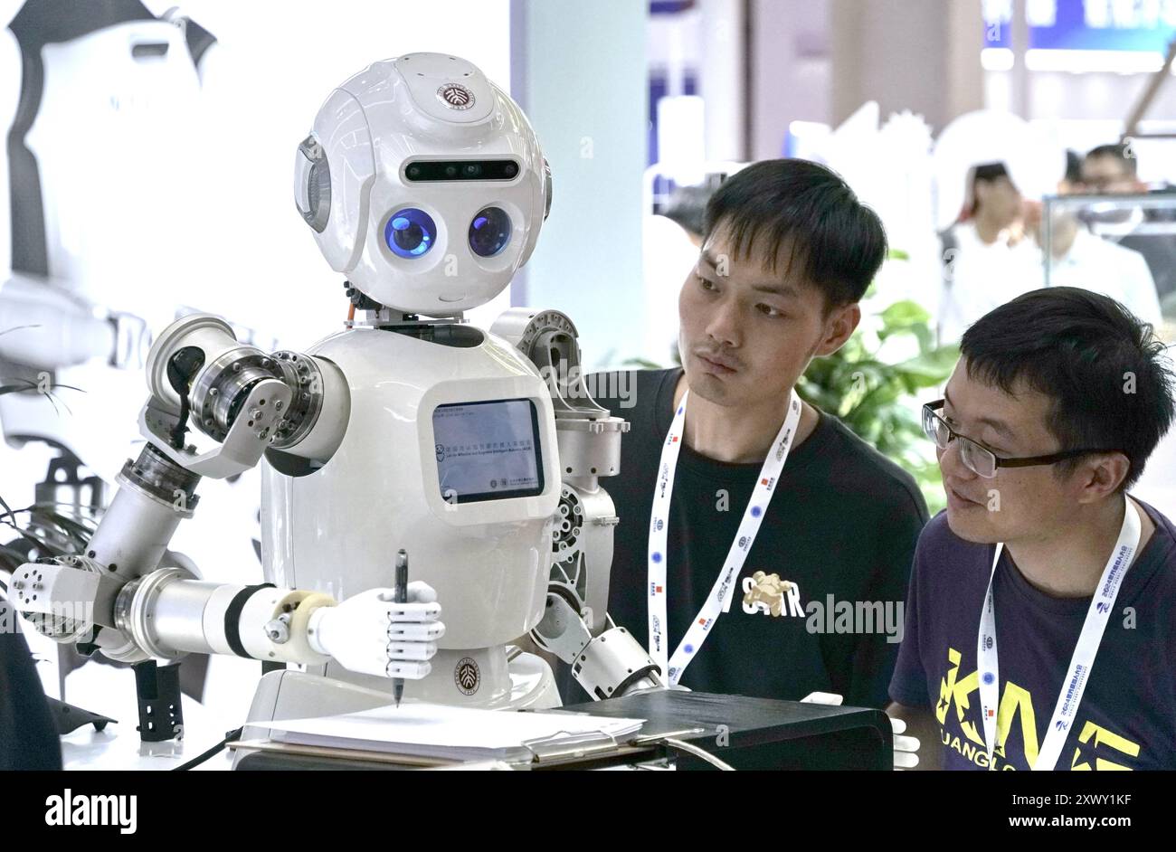 Beijing, China. 21st Aug, 2024. Visitors examine an educational robot during the World Robot Conference 2024 in Beijing, capital of China, Aug. 21, 2024. The World Robot Conference 2024 opened here on Wednesday. Credit: Li Xin/Xinhua/Alamy Live News Stock Photo
