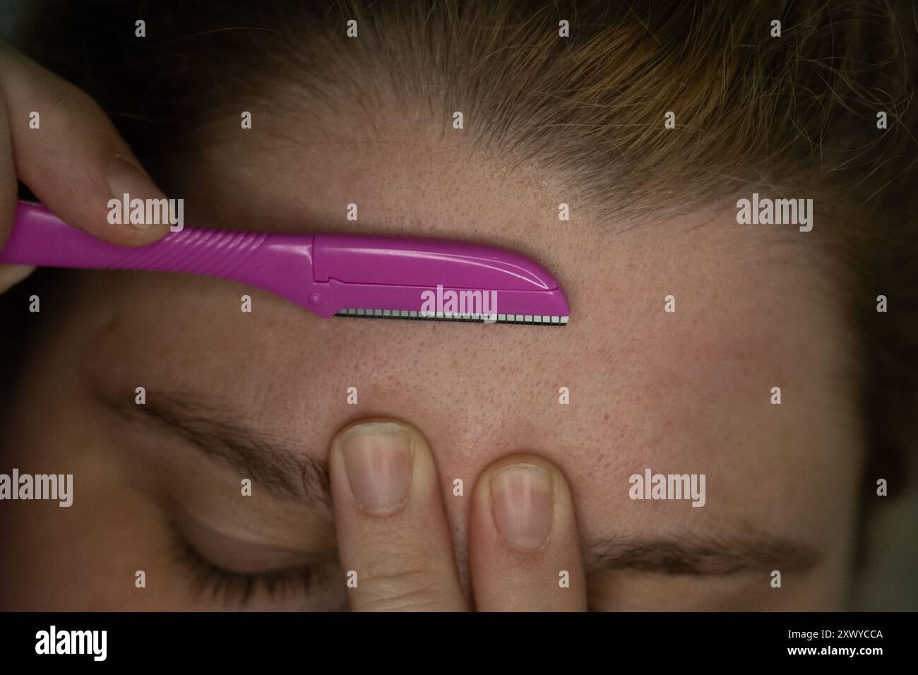 Berlin, Germany. 21st Aug, 2024. A woman holds a razor, which can also ...