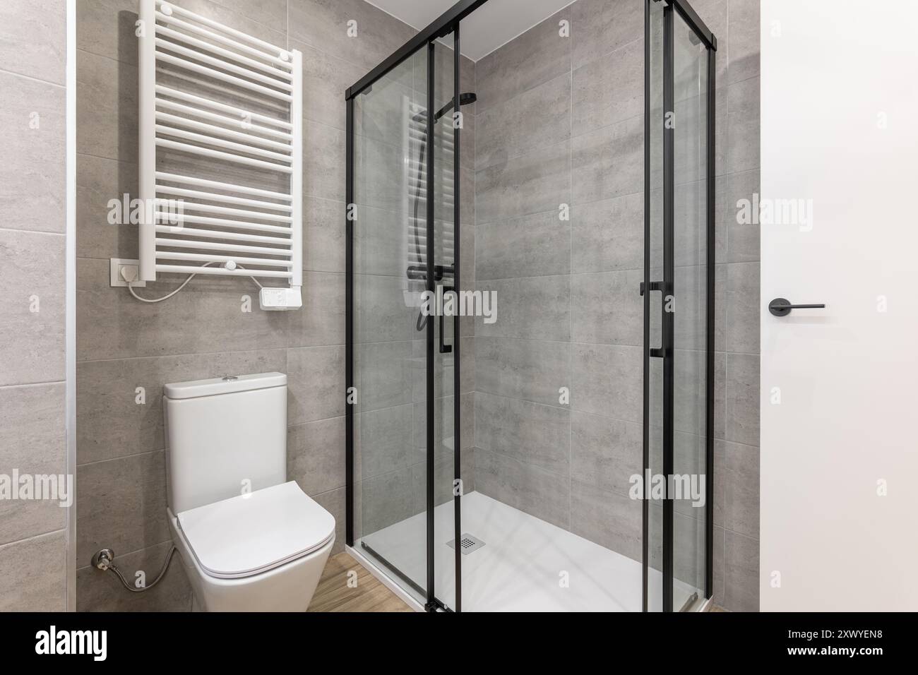 Modern bathroom with glass shower and slim toilet complements the ...