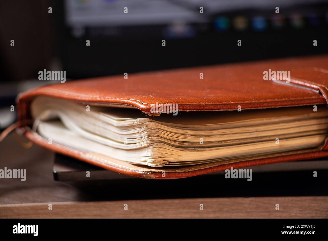 Leather brown notebook lies on black laptop in office, workbook, diary ...