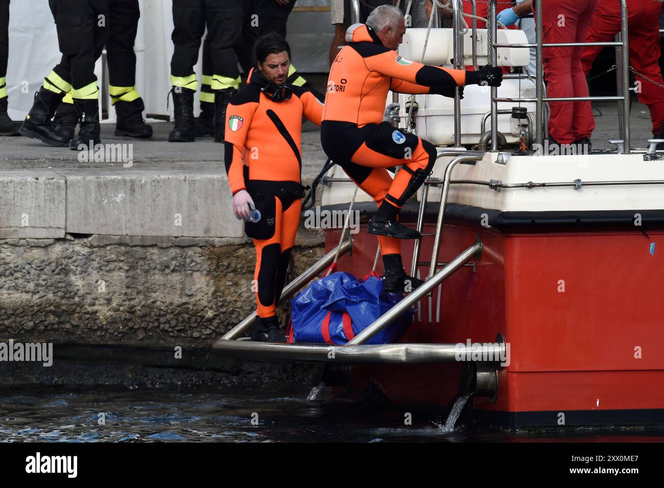 Italian Firefighters scuba divers bring ashore in a blue bag the body ...