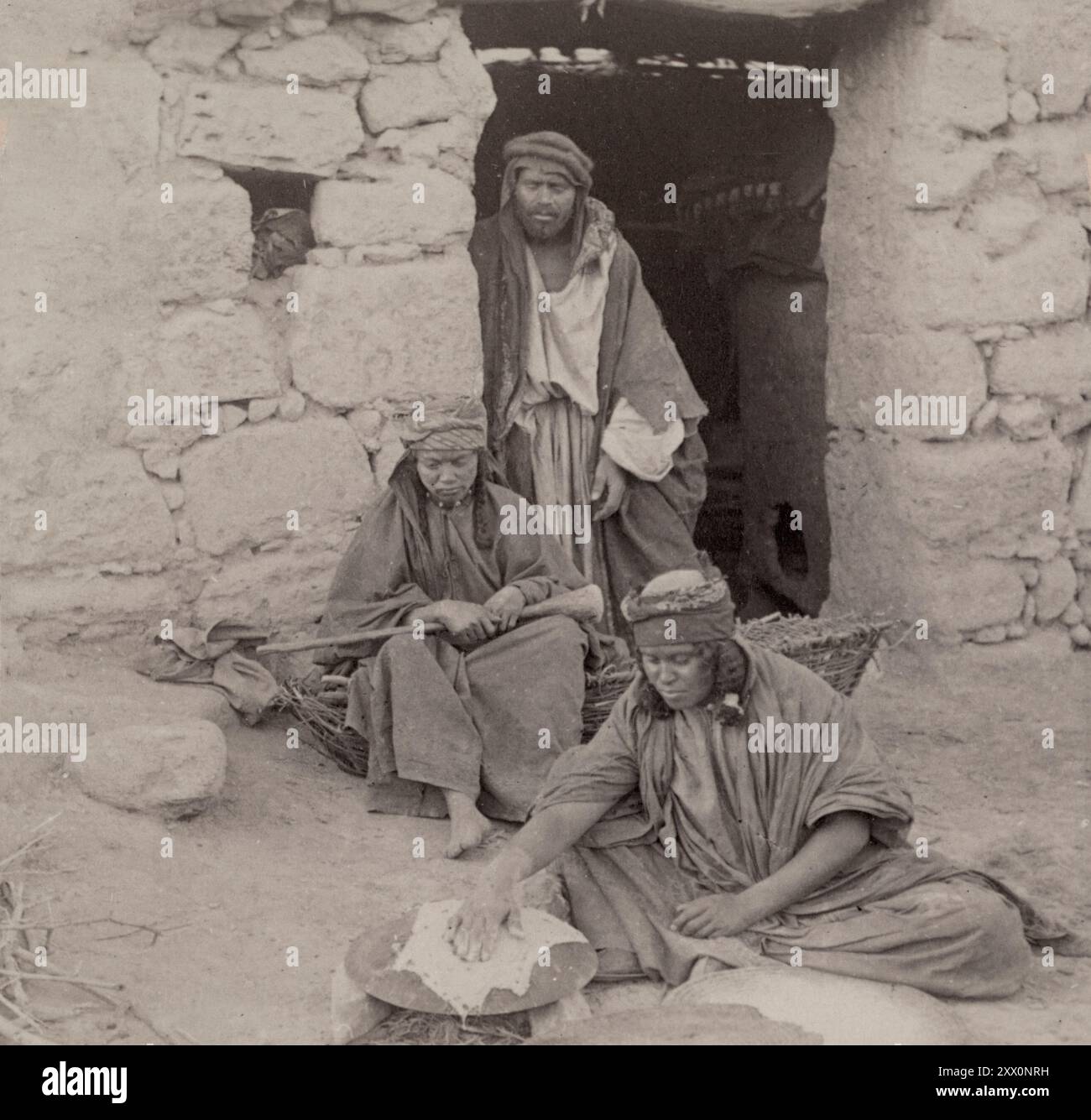 Life in Palestine in the late 19th and the early 20th century. A woman of modern Jericho, baking unleavened bread. Historic Palestine. Ottoman Empire. 1890-1900 Stock Photo