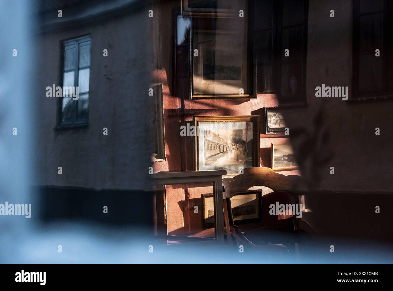 Old pictures lit up in the evening sun at the Mariager Museum in Mariager, Denmark Stock Photo