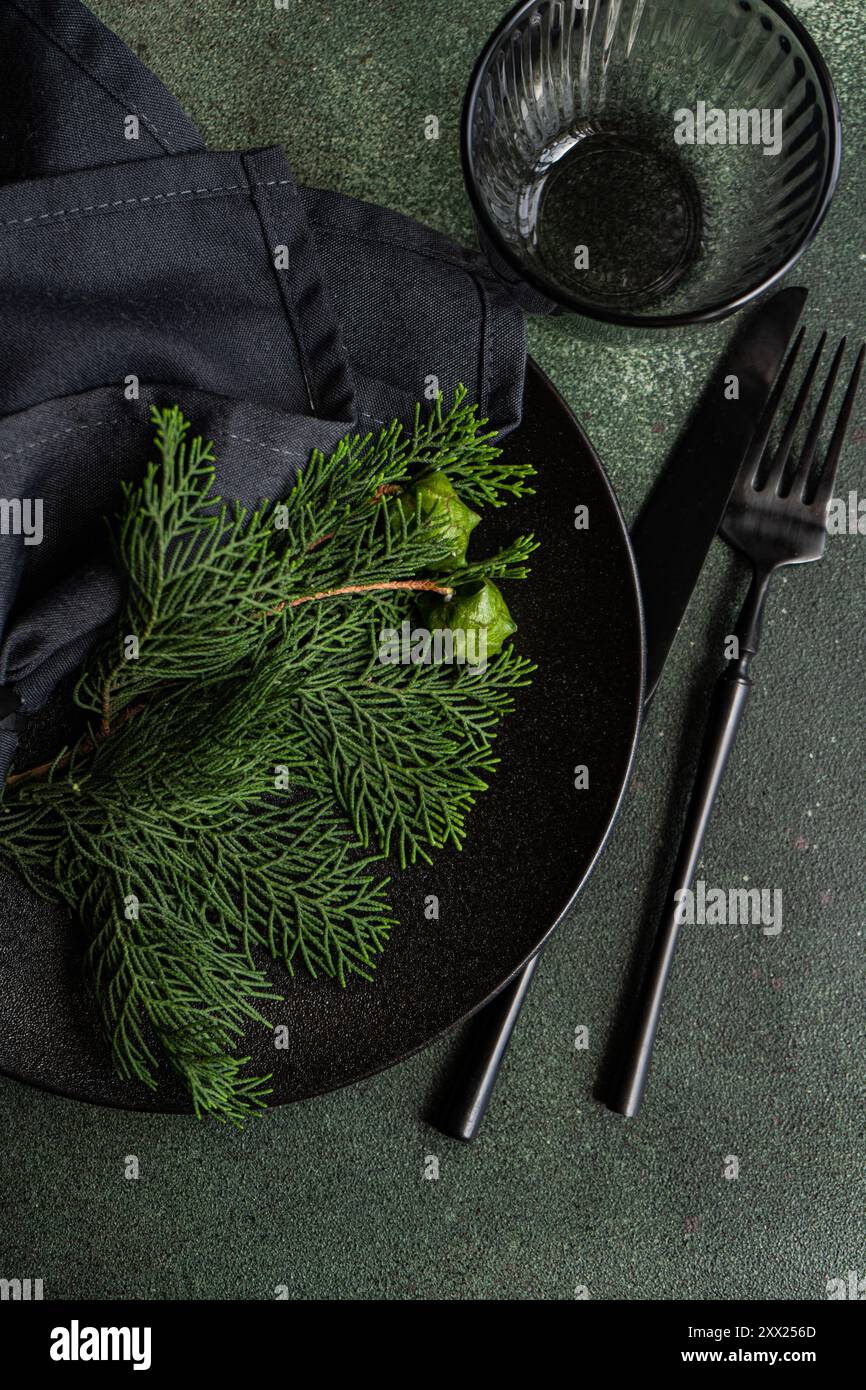 Overhead view of a Christmas place setting with fresh thujia branches Stock Photo