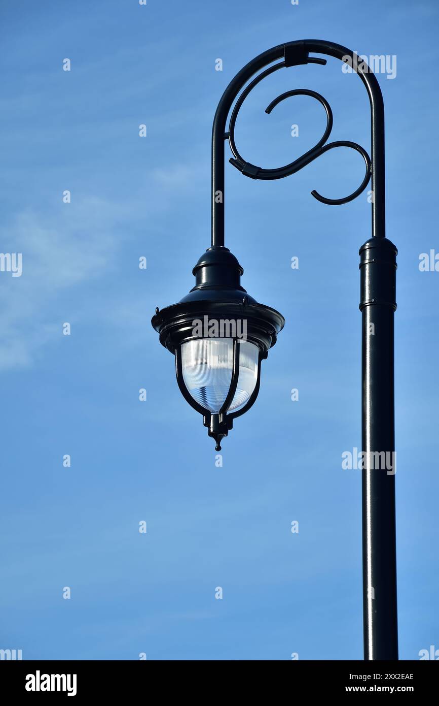 Black architectural pole street light with blue sky Stock Photo