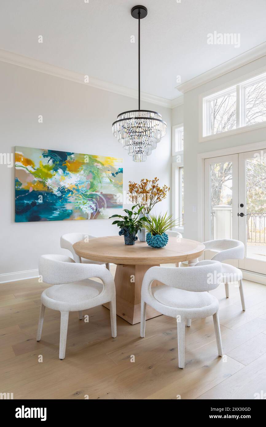 Dining room with round Arhaus Leighton wood table and white Hawkins ...
