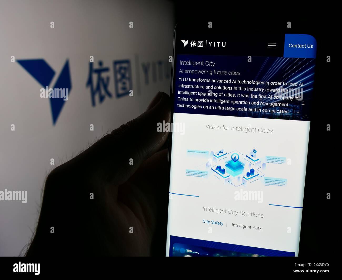 Person holding smartphone with webpage of Chinese AI company Shanghai YITU Technology Co. Ltd. in front of logo. Focus on center of phone display. Stock Photo