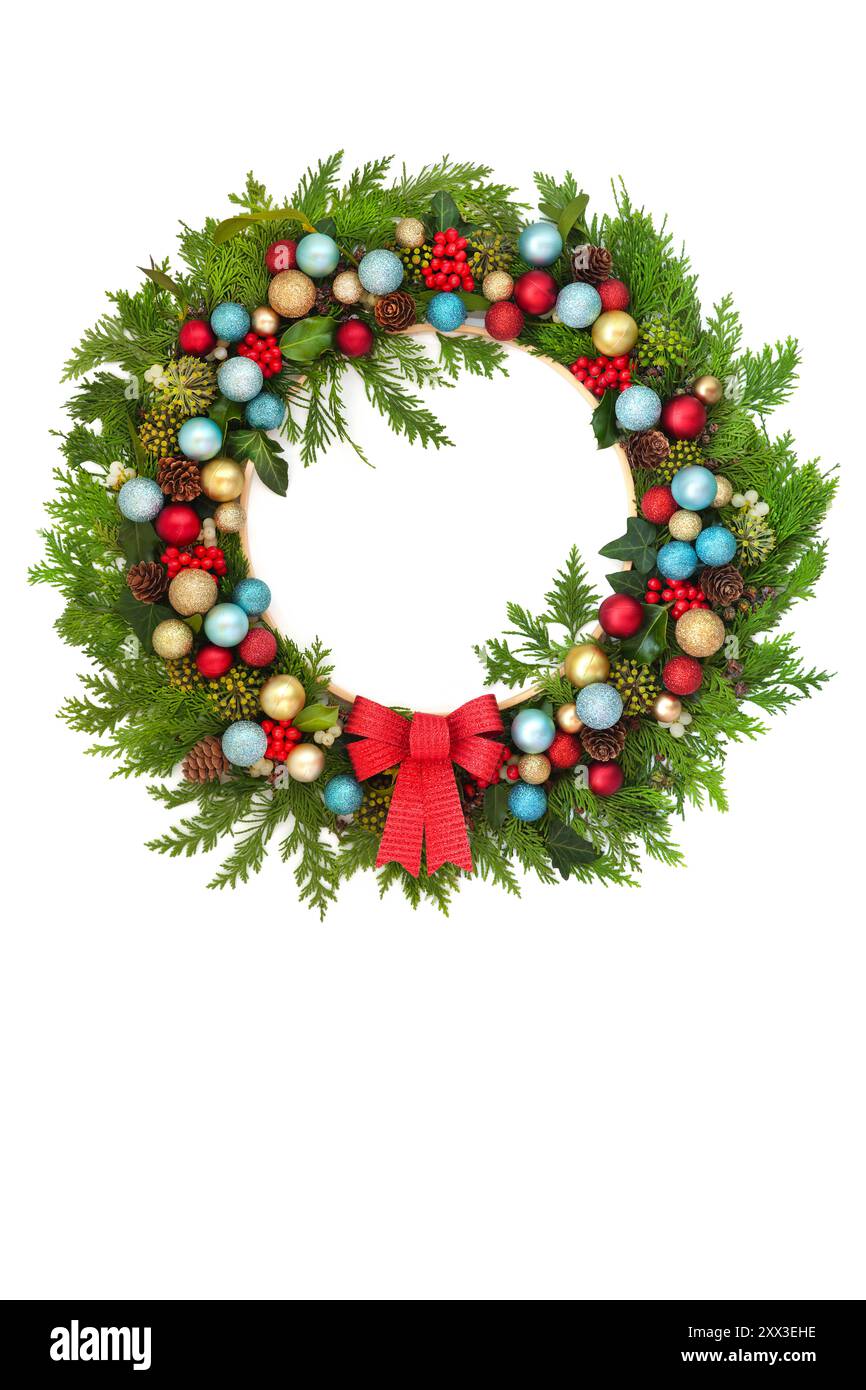 Christmas evergreen wreath decoration with bulb baubles, holly berries ...