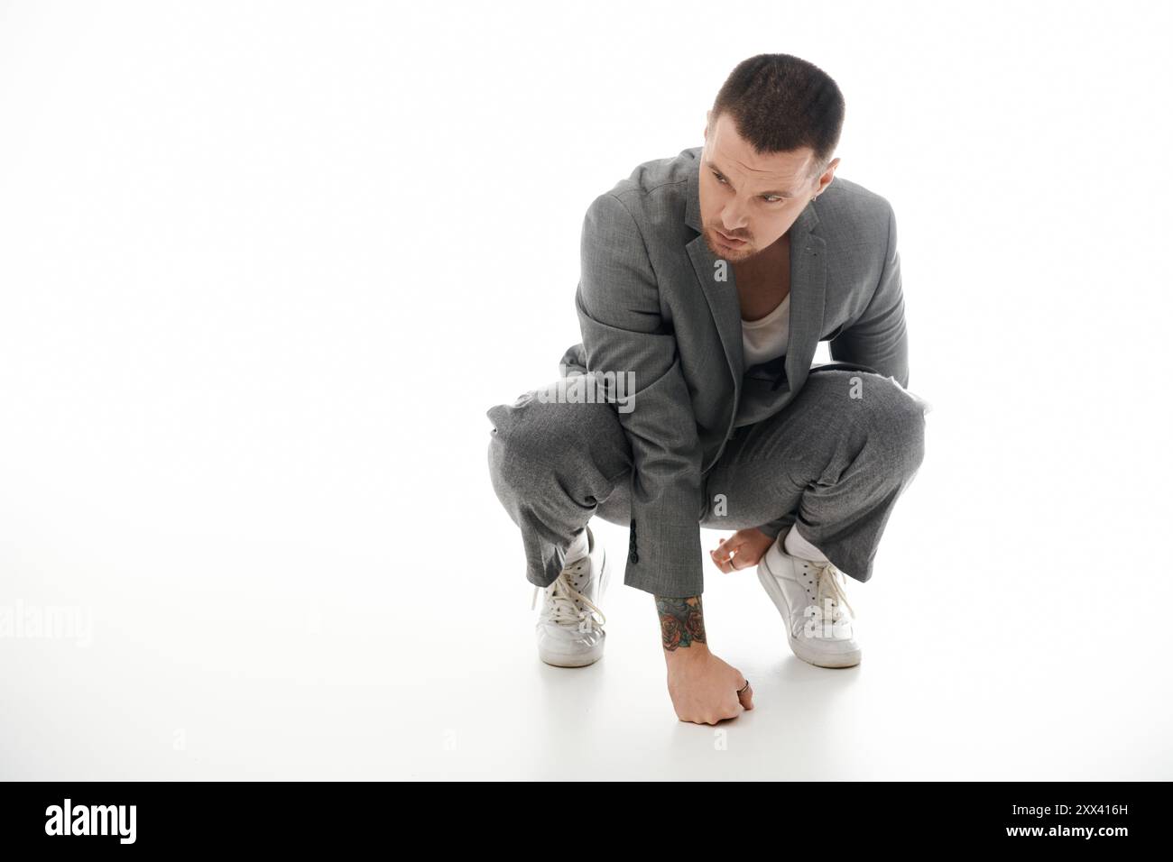 Man kneeling suit hi-res stock photography and images - Alamy