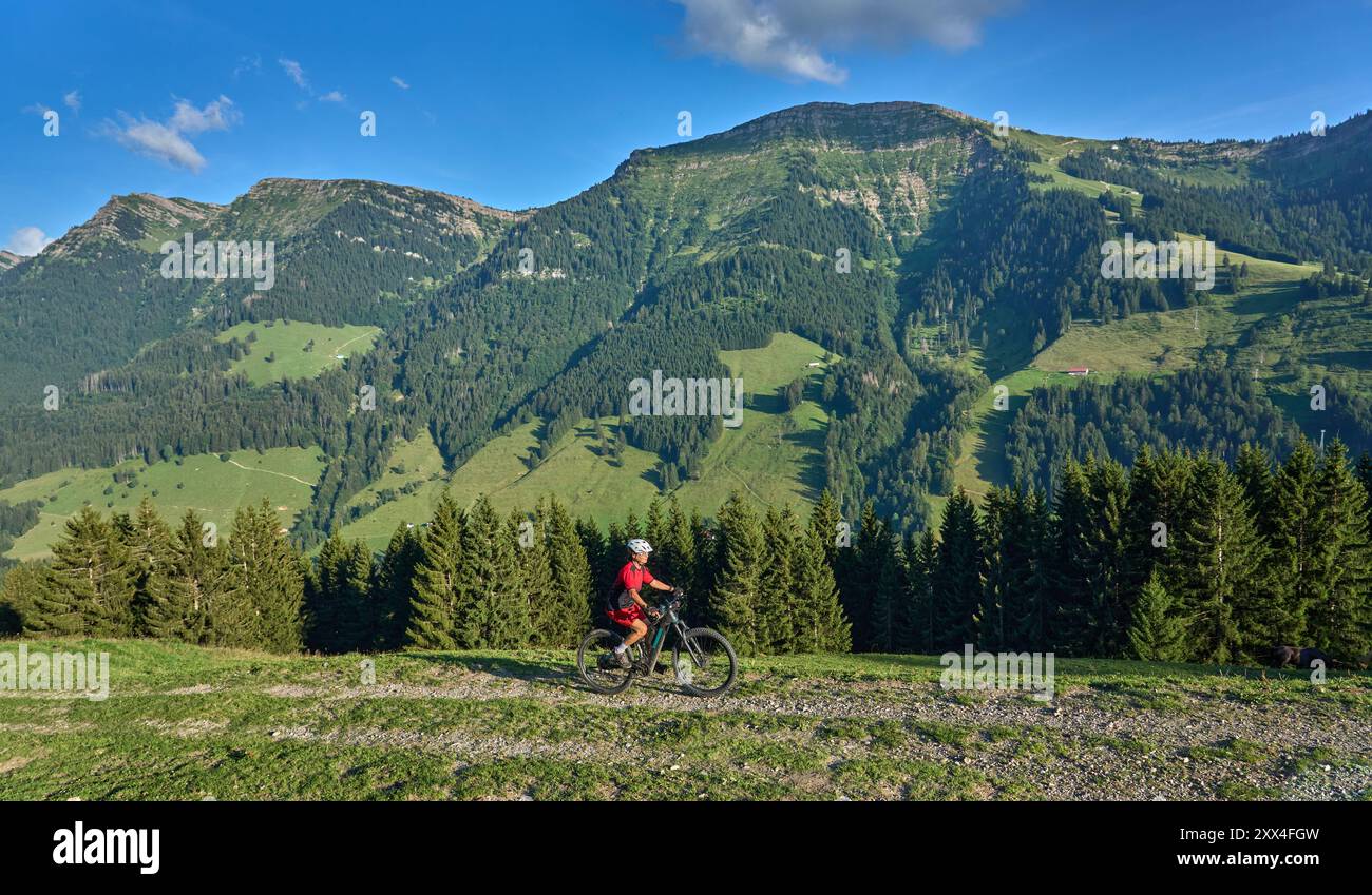 pretty senior woman riding her electric mountain bike and enjoying the ...