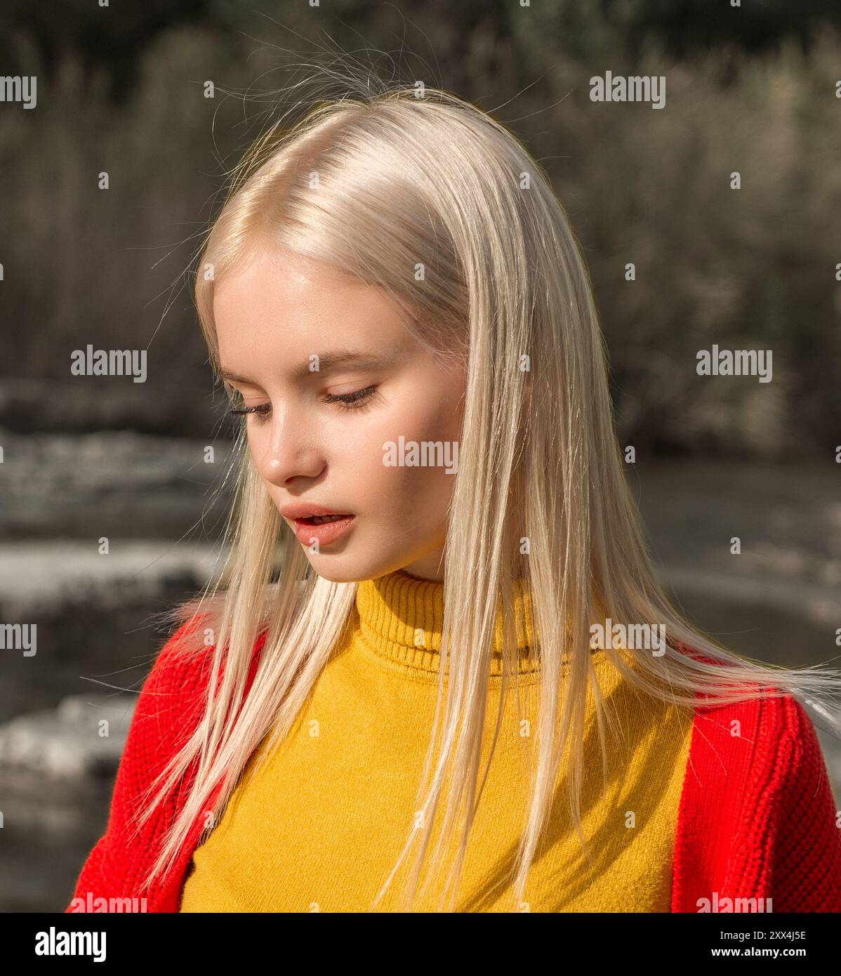 Portrait of a girl in a yellow shirt and a red sweater Stock Photo