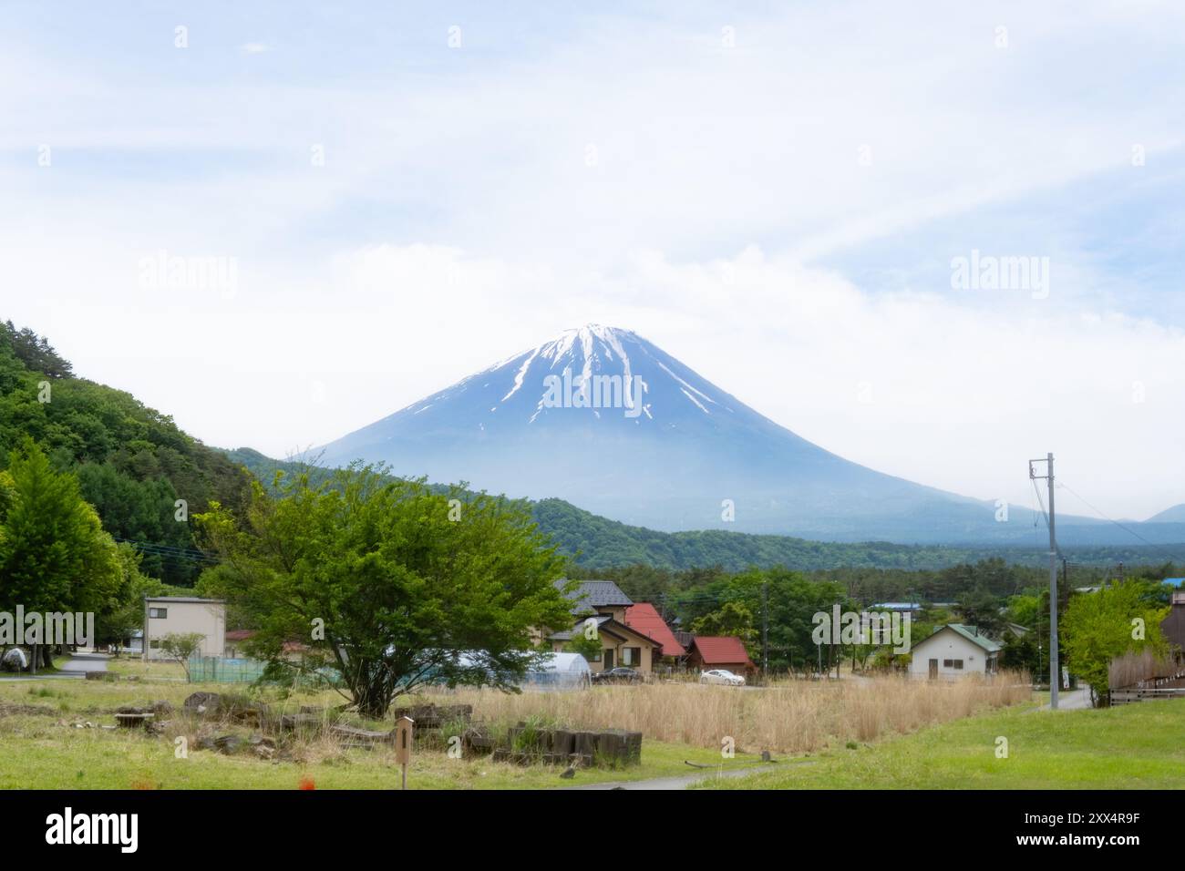 Traditional thatched-roof homes with Mt. Fuji in the background on a clear day – Yamanashi Prefecture, Japan Stock Photo