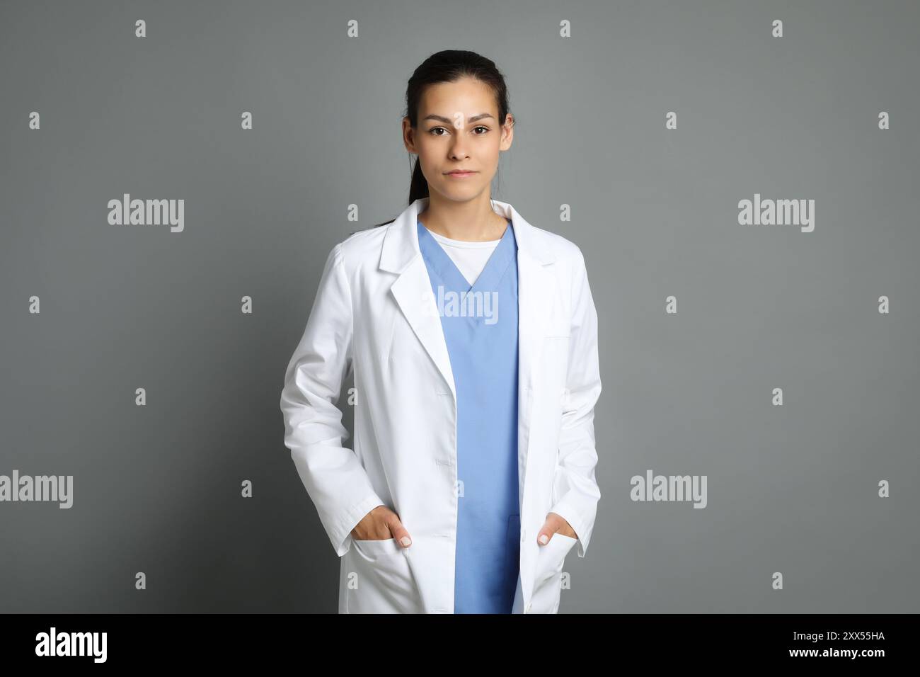 Young beautiful nurse on grey hi-res stock photography and images - Alamy