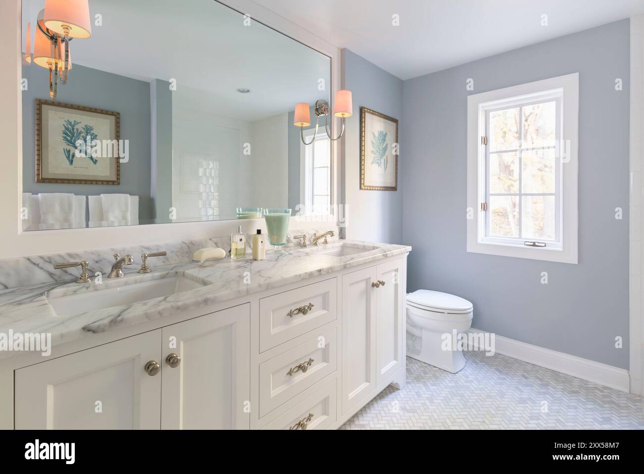 Beautiful bathroom with blue walls and double vanity with marble ...