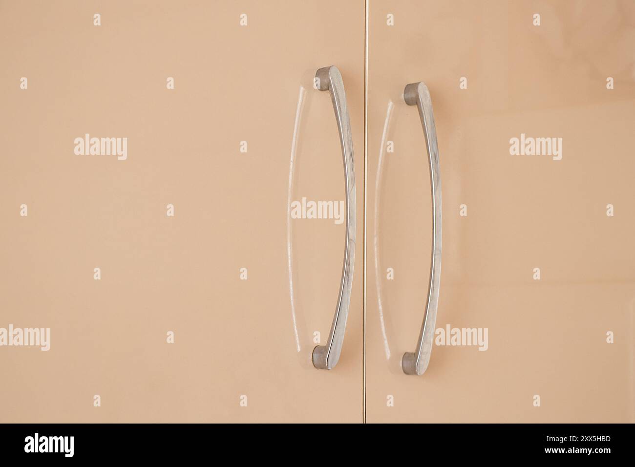 Beige kitchen with handles as background, closeup of kitchen