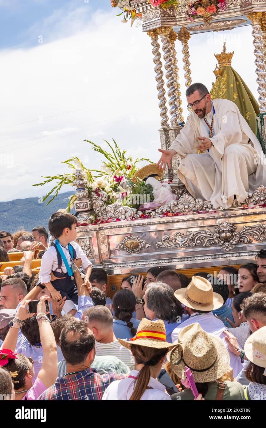 Virgen de la Cabeza, Andujar, Jaen Province, Andalusia, Spain. April 30, 2023. Priest being carried on a float at the annual pilgrimage for the Virgen Stock Photo