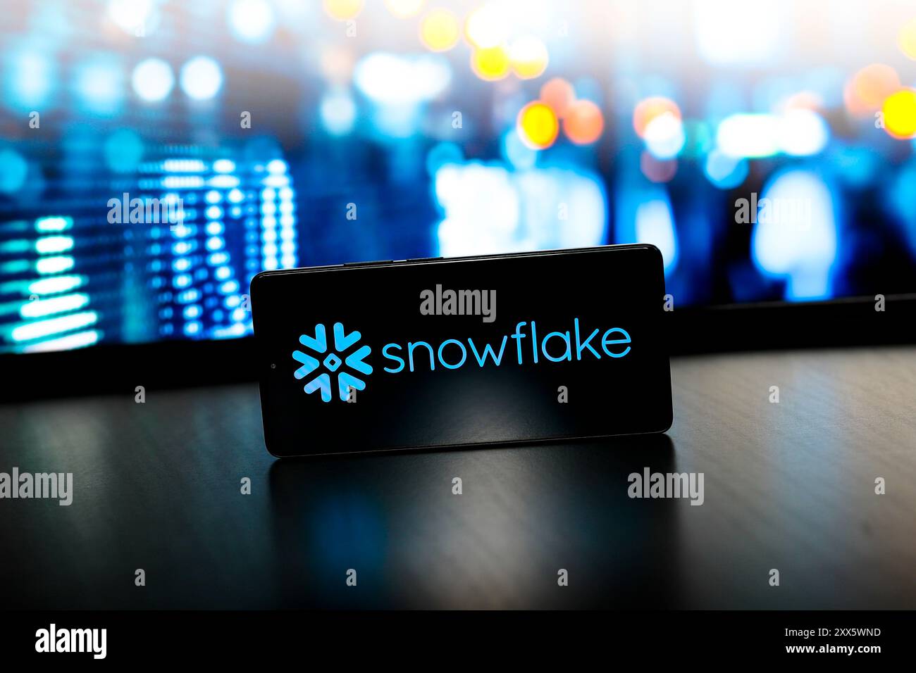 In this photo illustration, the Snowflake logo is displayed on a ...