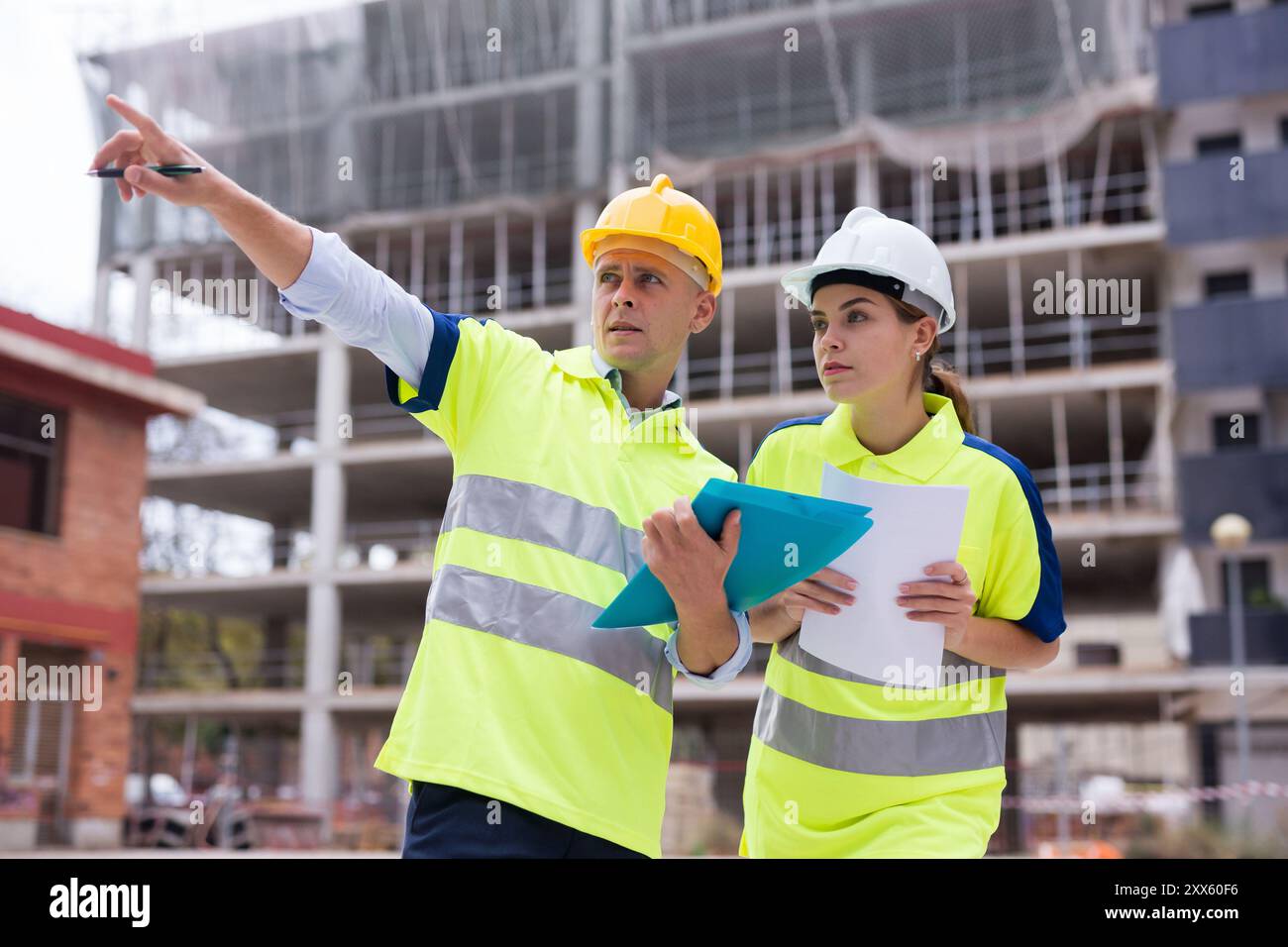 Two qualified engineers are discussing a construction plan Stock Photo