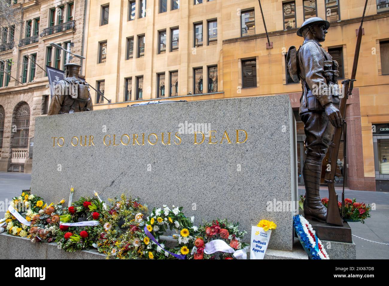 Sydney Cenotaph in Martin Place Sydney City centre, To our Glorious Dead, flowers and wreaths surround the stone and soldiers statue, Australia Stock Photo