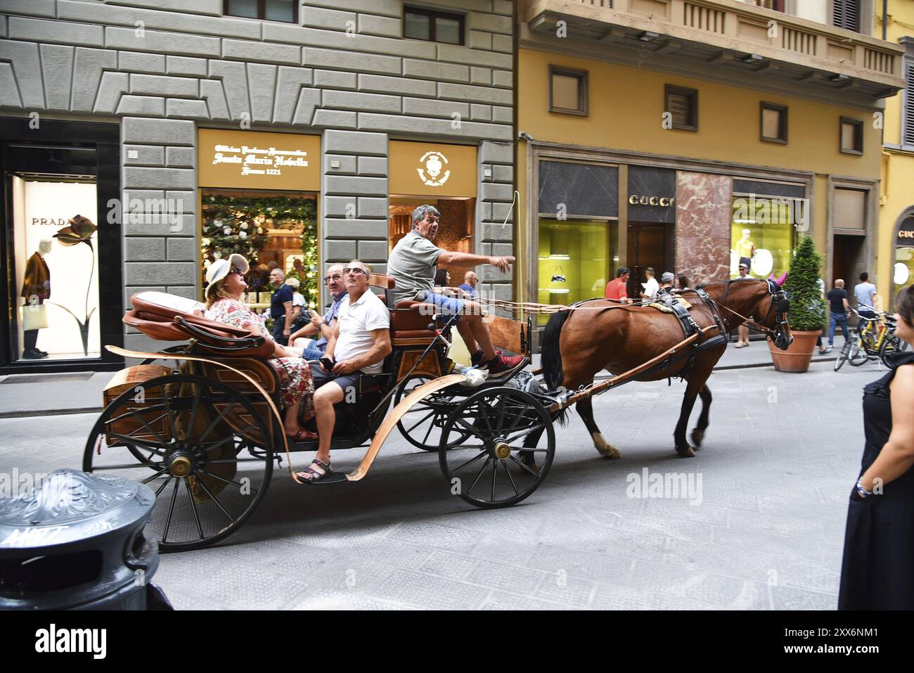 Florence, Italy. September 17, 2023. A carriage carrying tourists in an upscale shopping street in Florence Stock Photo