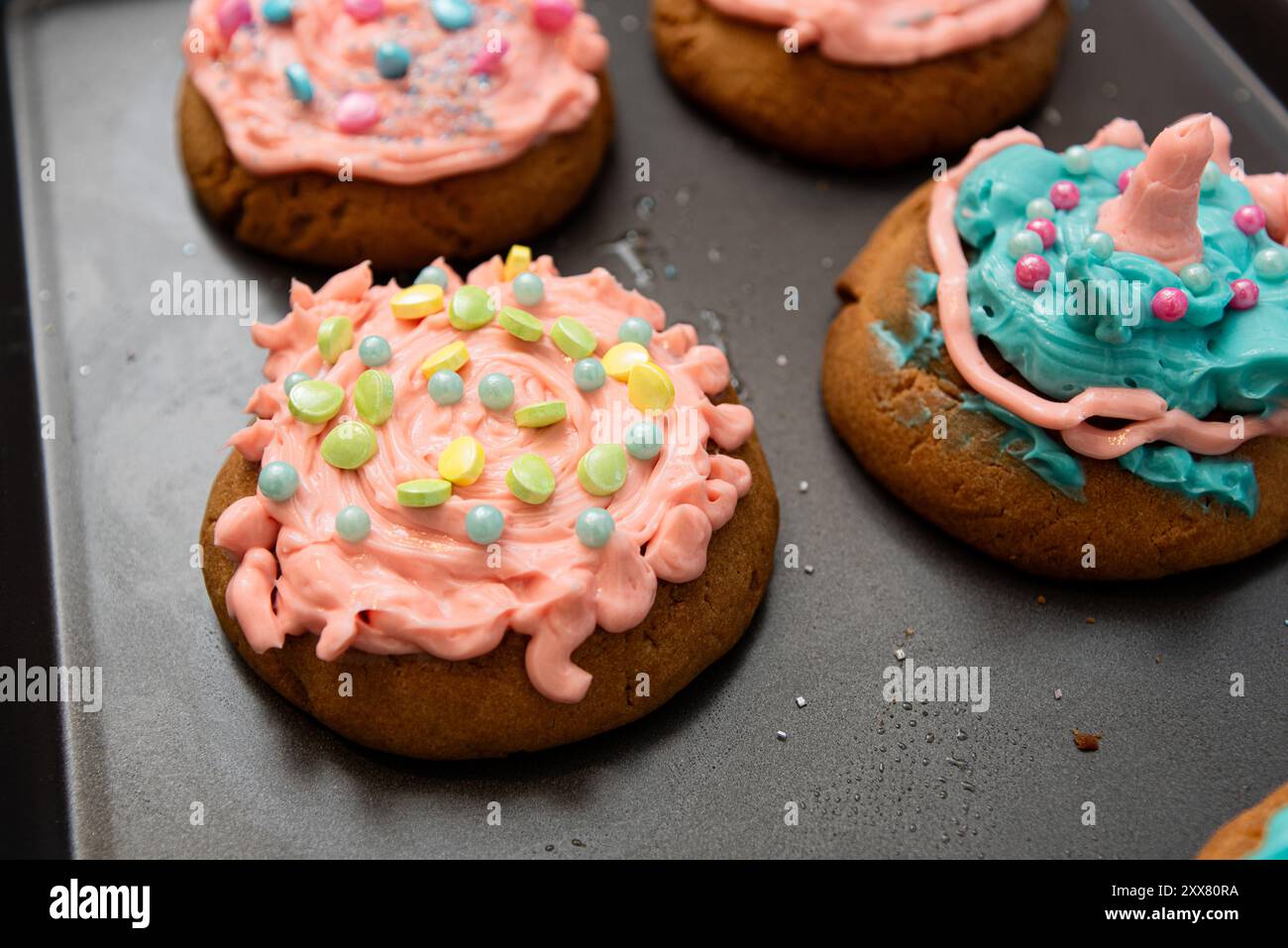 Close-up of beautifully decorated cookies with frosting and sprinkles. Stock Photo